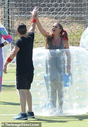 Cartwright looked set to crawl into a clear plastic ball. She was seen high-fiving one of her co-stars.