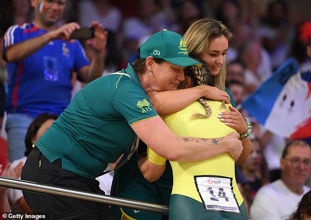 Reid celebrates with his team after an emotional victory at the Paris Games velodrome