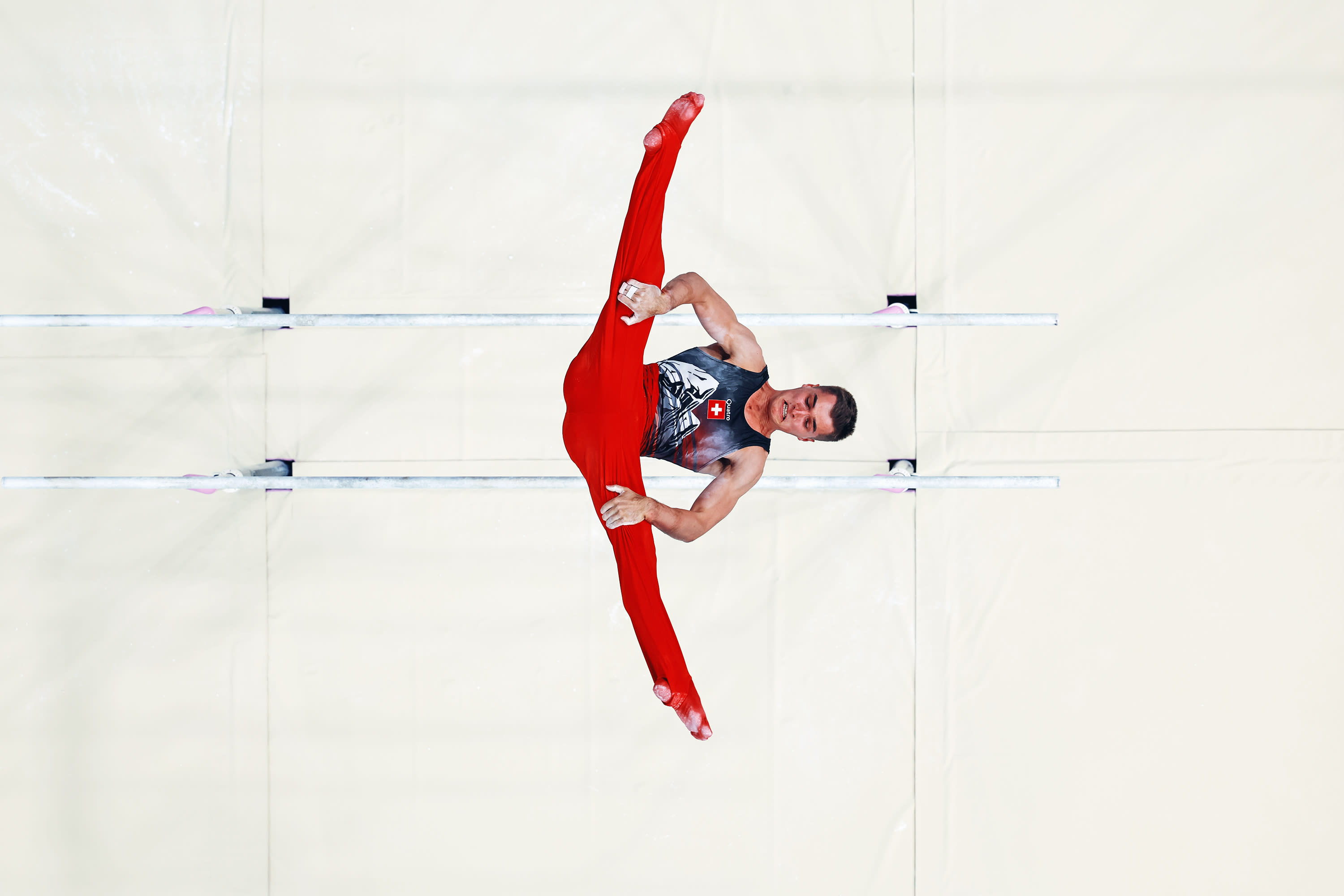 (EDITOR'S NOTE: This image was captured with a robotic camera positioned above the playing field) Florian Langenegger of Team Switzerland competes on the parallel bars during the Men's All-Around Artistic Gymnastics Final on day five of the Paris 2024 Olympic Games at Bercy Arena on July 31, 2024 in Paris, France. (Photo by Dan Mullan/Getty Images)