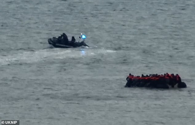 With blue and red lights flashing, the speedboat passed close to the boat a couple of times, warning it to turn around and head for shore.