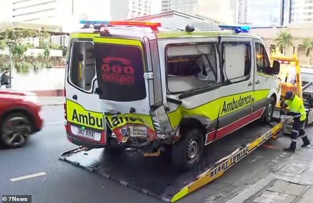 The black Model 3 struck street poles before crashing into the ambulance on Ann Street around 3 p.m.