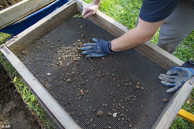 The excavation also unearthed a pierced coin that young African-American men often carried as a good luck charm.