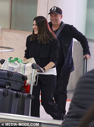 Karl, 49, and Sarah, 38, were all smiles as they touched down on home soil at Sydney Airport, looking happy and fresh-faced after the 20-plus hour flight.