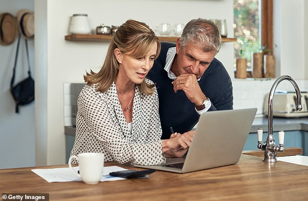 The barefoot investor said it was time to save for retirement after spending $500,000 pre-tax on his daughter's education (Stock photo of middle-aged couple looking at their finances)