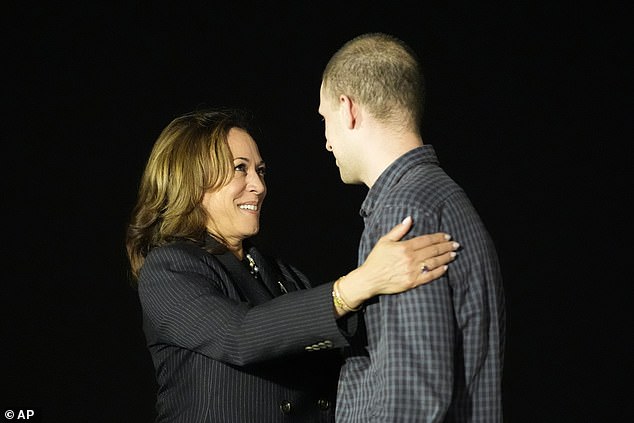 Harris is seen here greeting the wrongfully imprisoned Wall Street Journal reporter shortly before midnight.