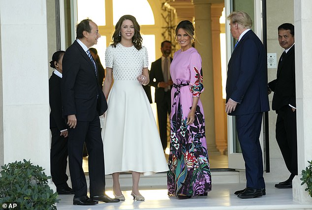 Pictured: Former President Donald Trump, right, stands with Melania Trump, second from right, as they are greeted by John Paulson, left, and Alina de Almeida, second from left, at a Republican Party fundraiser.