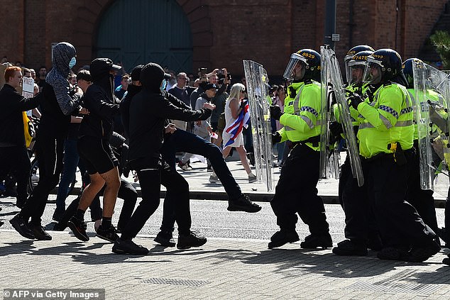 Police officers confront protesters outside the Royal Liver Building in Liverpool on August 3 during the 'Enough is Enough' demonstration