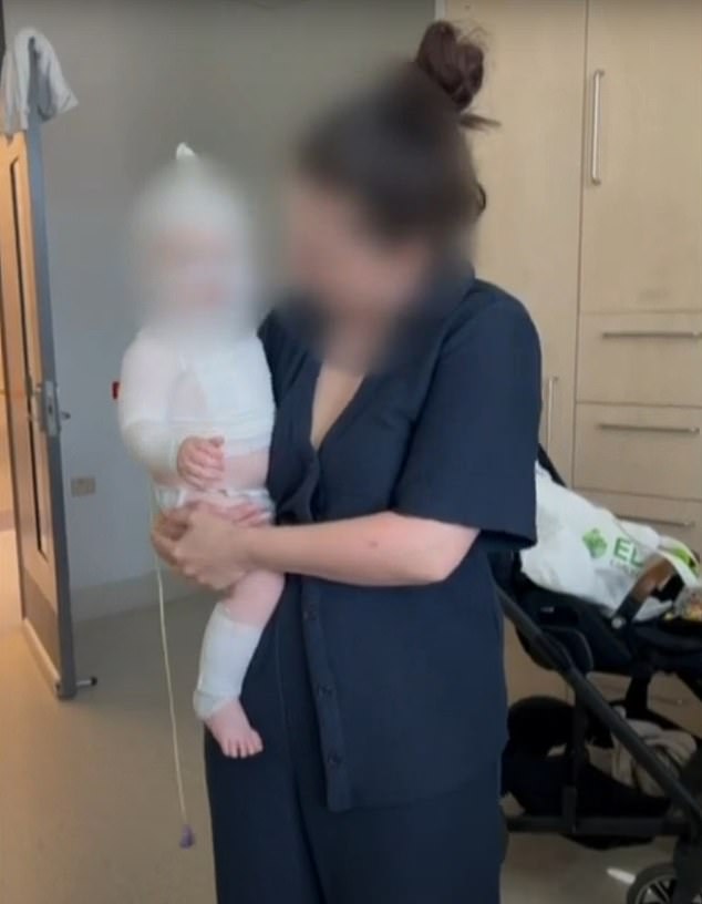 The baby (pictured with his mother) was enjoying a picnic with his mother and friends when a stranger approached and poured hot coffee on him.