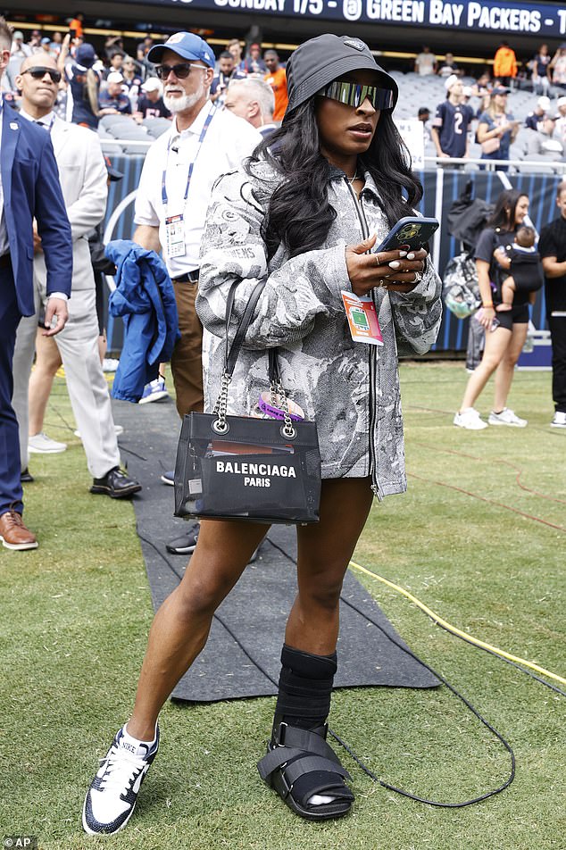 As she walked the sidelines, Biles also sported a protective boot on her left foot.