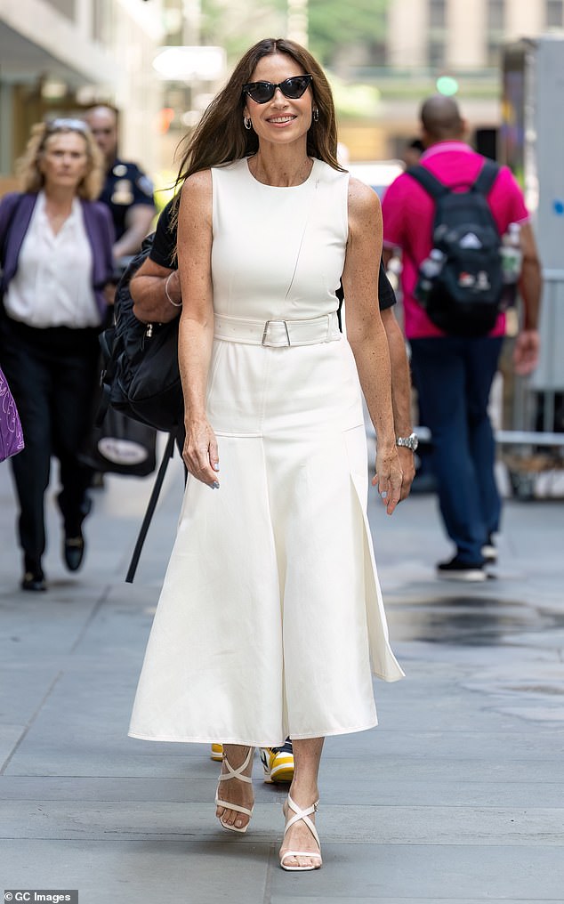 Actress Minnie Driver, 54, wears a white, sleeveless, calf-length dress in New York in June.