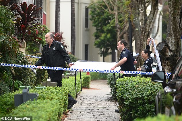 Queensland Police officers are seen in the unit where the ten-year-old boy was found.