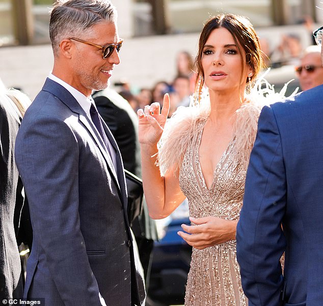 The disease, which can cause paralysis and eventually death, claimed the life of Sandra Bullock's co-star Bryan Randall (pictured with Sandra Bullock in 2018) last year.