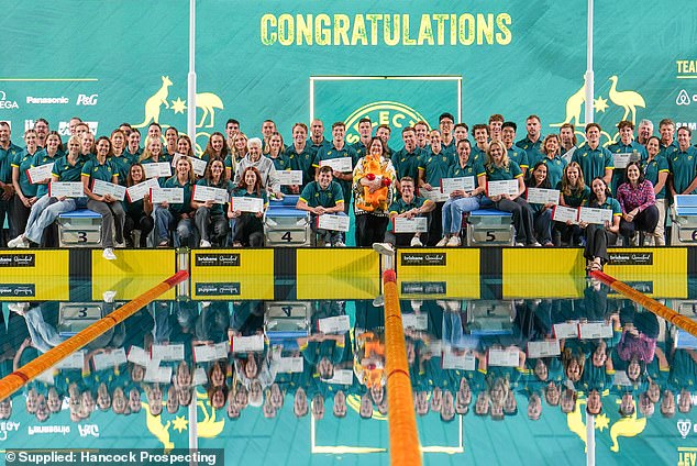 Mr Rinehart (centre) poses with the Australian Olympic swimming team he helps support.