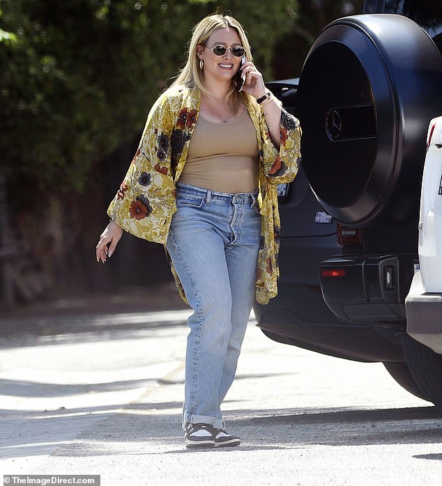 The 36-year-old actress showed off her svelte postpartum figure, wearing a nude swimsuit and a pair of high-waisted jeans with Nike sneakers.