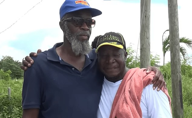 Jahmari's heartbroken father, Michael Reid (right), was on the beach when his son's remains were brought back to land.