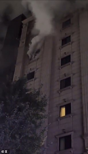 Smoke is seen coming out of a window of the hotel.