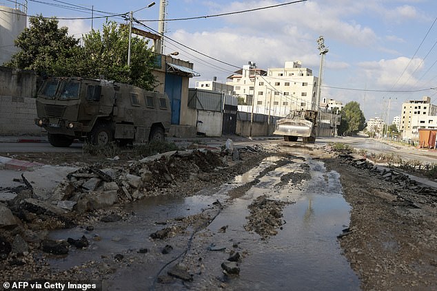 Israeli military vehicles drive along a road during a raid in the northern town of Tulkarm in the occupied West Bank