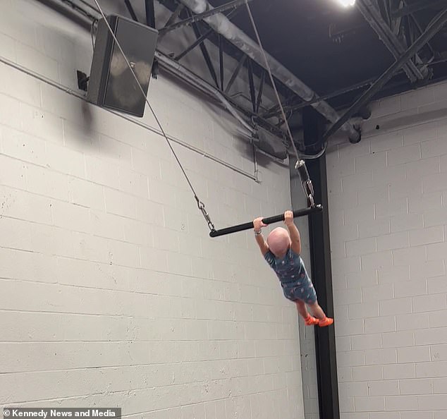 Her mother, Aimee, 28, says she was so impressed with her little girl's abilities that she enrolled her in gymnastics classes in the hope that she could become a gymnast. Pictured: Reighlynn on the trapeze