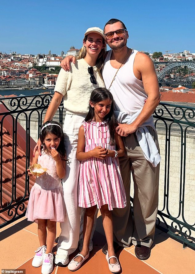 The couple posed with two adorable little girls.