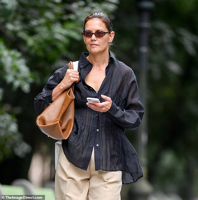 She added slightly oversized khaki pants with a brown leather Khaite bag over her shoulder.