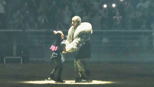 Fashionista North, 11, turned heads in a fur-trimmed jacket and combat boots as she swayed to the music under the floodlights at Goyang Stadium.