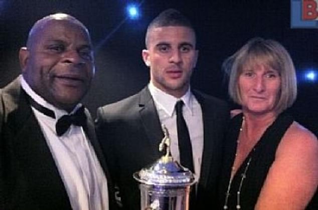 The professional footballer, 34, who grew up on Lansdowne Estate in Sheffield, revealed how his upbringing on a council estate has influenced his own upbringing (pictured with parents Michael and Tracey)