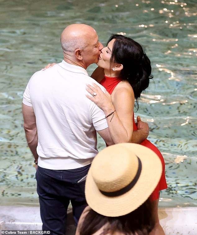 Lauren Sanchez stunned in a vibrant red, backless minidress as she kissed her fiancé, Jeff Bezos.