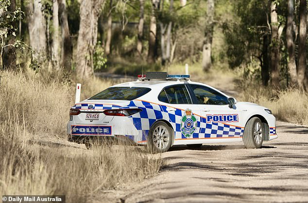 Police are seen arriving at Crawford's rural property on Thursday.