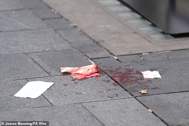 The 11-year-old girl from New South Wales suffered injuries to her wrist, shoulder, face and neck (pictured, blood on the pavement at the scene in Leicester Square, London)