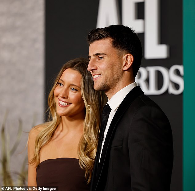 The lovebirds led the arrivals at Centrepiece with the Magpies midfielder, 21, looking dapper in a monochrome suit and tie.