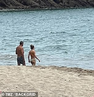 The couple was seen walking side by side on the sand.