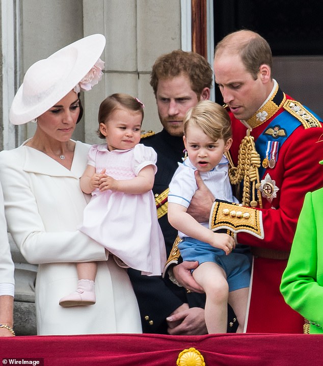 Kate (left), Princess Charlotte, (left), Prince George, (right), Prince Harry, (center) and Prince William (right) stand on the balcony during the flag parade in 2016.