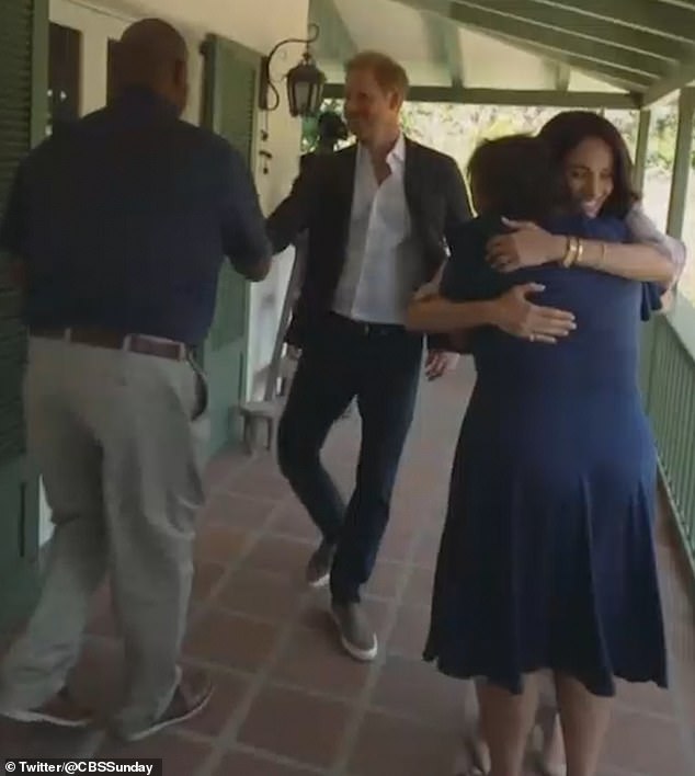 Harry and Meghan were pictured hugging parents from The Parents' Network as they met in person for its launch.