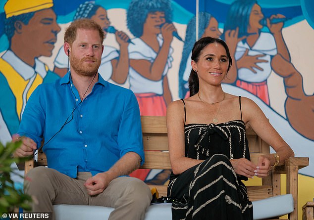 Harry and Megan sit together at the Cabildo Drum School