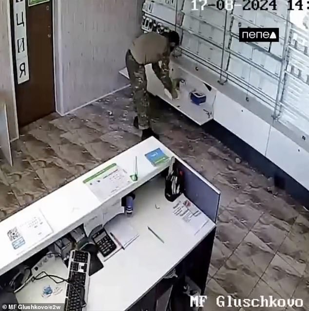 A wrestler is seen rummaging through drawers beneath cabinets.