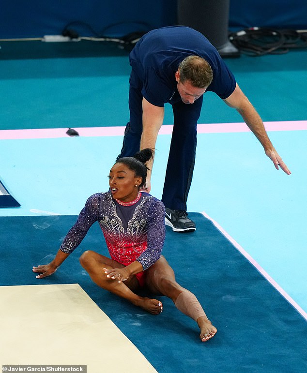 Biles fell while warming up for her floor routine, apparently aggravating a calf problem.