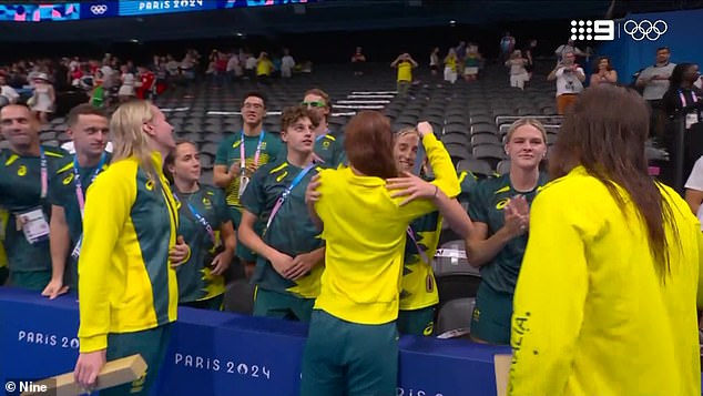 Australian swimming star Mollie O'Callaghan has hung her latest gold medal around the neck of teammate Jamie Perkins