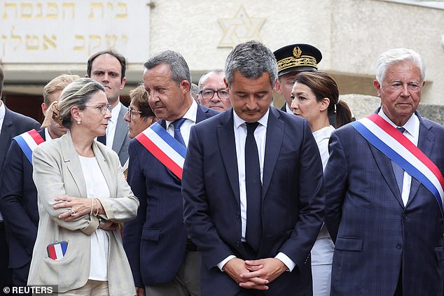 French Interior Minister Gerald Darmanin stands in front of the city's synagogue.