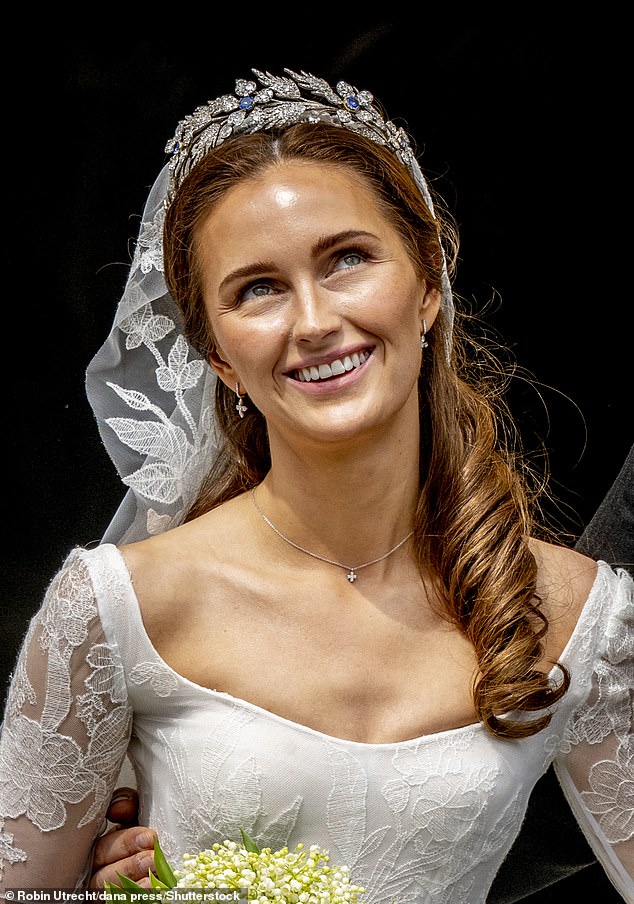 Criminology PhD student Sophie-Alexandra looked gorgeous in a classic white dress, with floral detailing on the princess-cut skirt and sheer long sleeves.