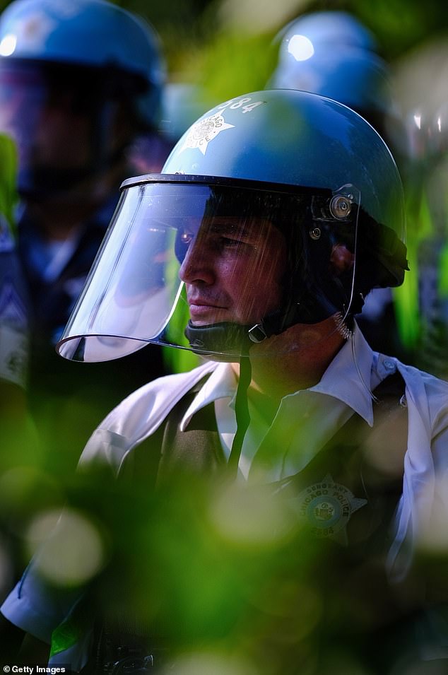 Chicago police watch protesters gathered during the Democratic National Convention on August 19, 2024 in Chicago, Illinois. Multiple protests are planned during the Democratic National Convention, which will be held at the United Center from August 19-22.