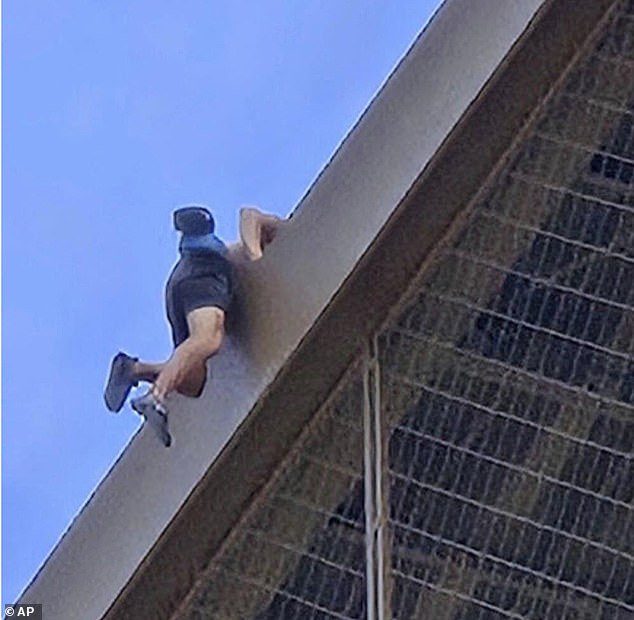 The image shows Davis climbing one of the iron beams on his way to the Eiffel Tower.