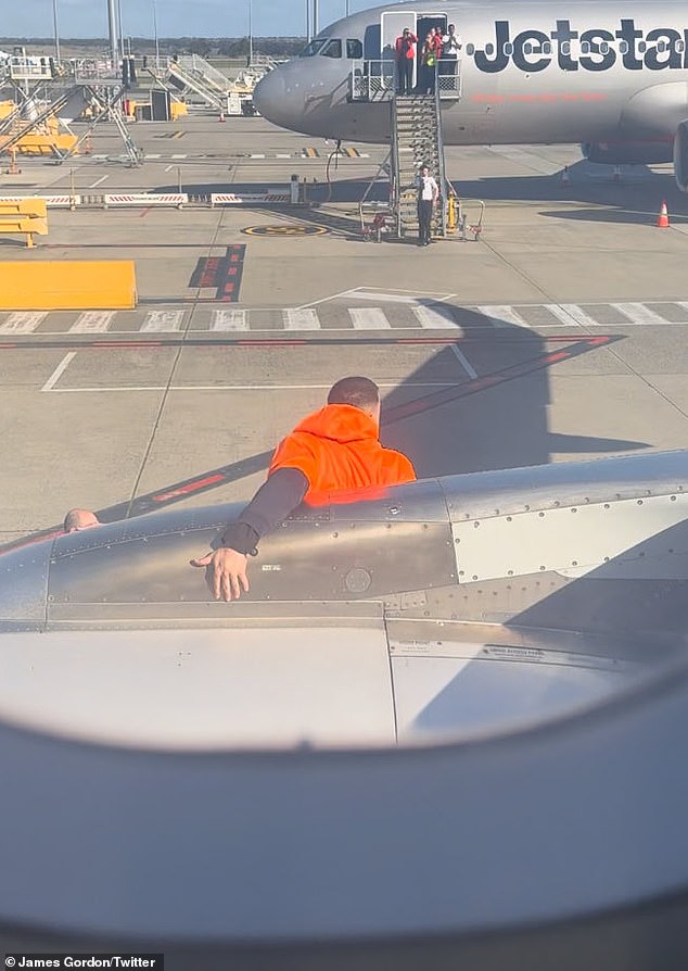 The man was seen on the wing of the plane, before jumping down the slide.