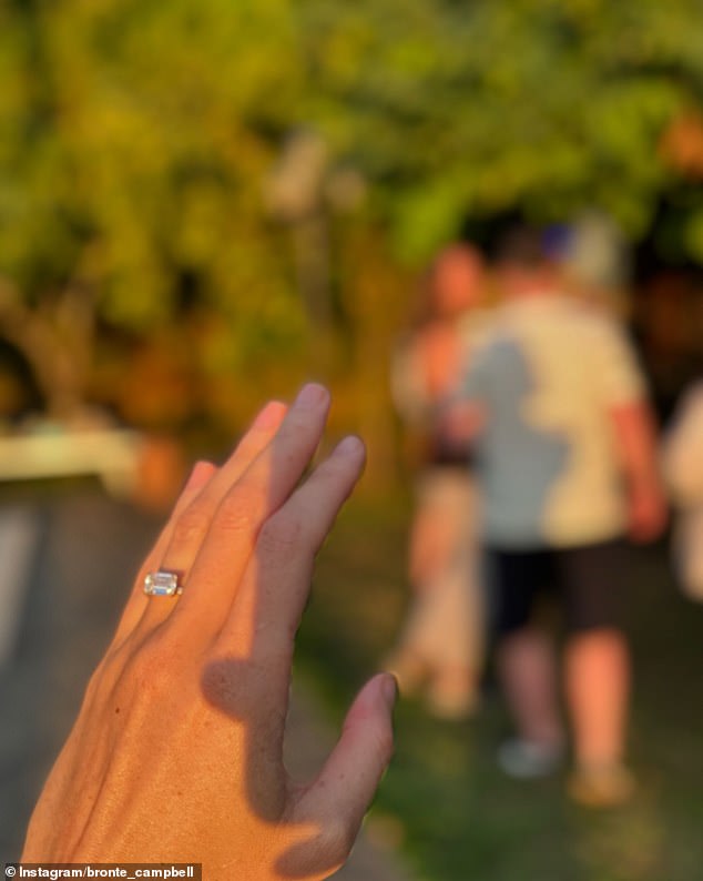 The four-time Olympic gold medalist shared a photo showing the stunning emerald-cut diamond set east to west on a gold band.