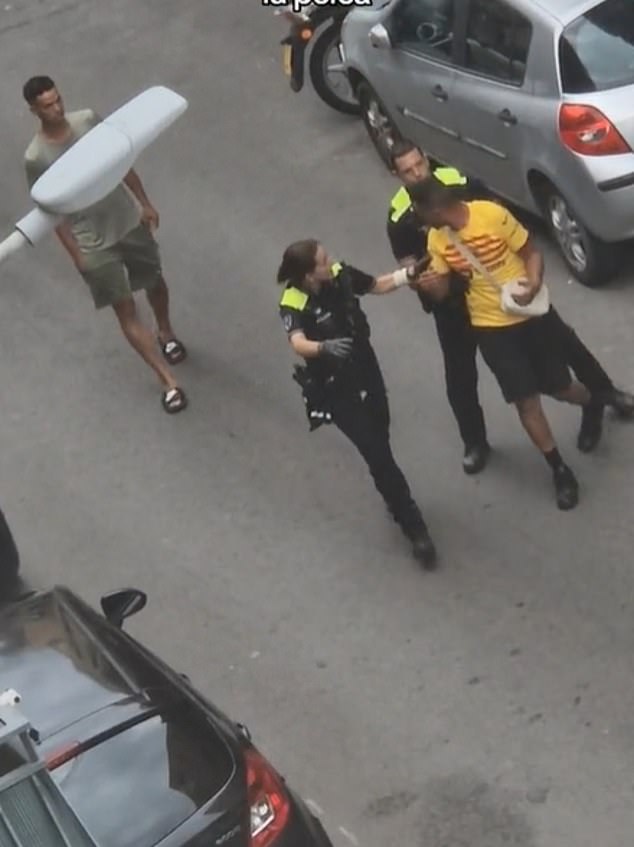 Images have emerged of Nasraoui (Barcelona yellow shirt) being led away by police after an alleged clash with neighbours