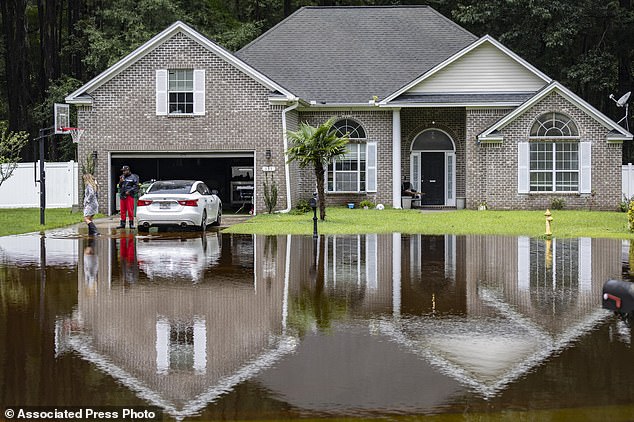 Keon Johnson and his wife Zyla Johnson, left, talk about commuting to work from home in 2024, in Pooler, Ga. (AP Photo/Stephen B. Morton)