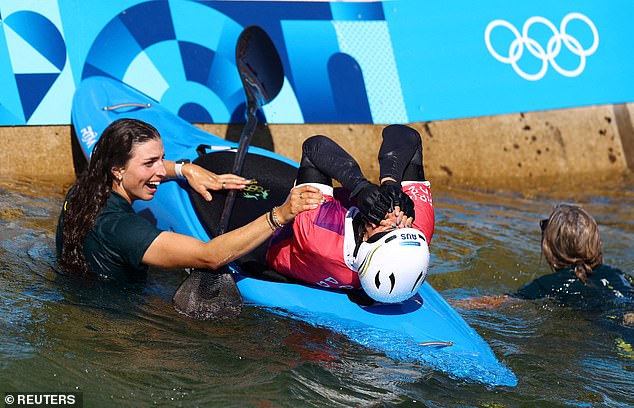 Jessica Fox is pictured after jumping into the water to celebrate with her sister following her stunning win.