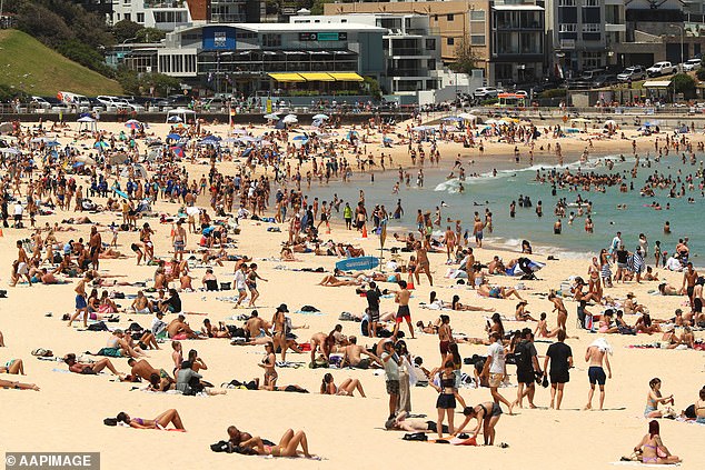 Anyone fancy a dip? Temperatures could rise enough over the weekend to break the record for the highest temperature ever recorded in August (pictured: people on the beach)