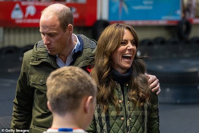 William puts his arm around Kate as they chat to members of a charity during a visit to Scotland last year.