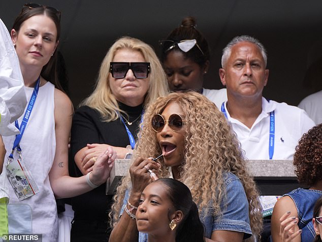 Williams is seen in the stands applying some lip gloss during third-round action.