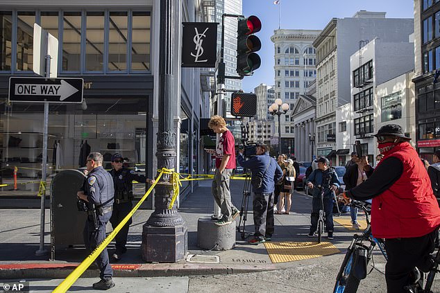 Police officers secure the area and investigate the scene of a shooting in Union Square